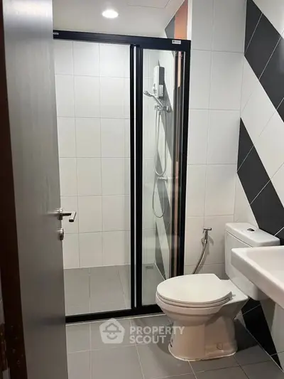 Modern bathroom with sleek shower enclosure and stylish tile design.