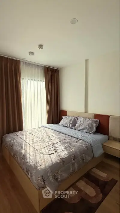 Cozy bedroom with elegant decor and natural light, featuring a comfortable bed and stylish curtains.