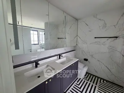 Modern bathroom with dual sinks and marble accents