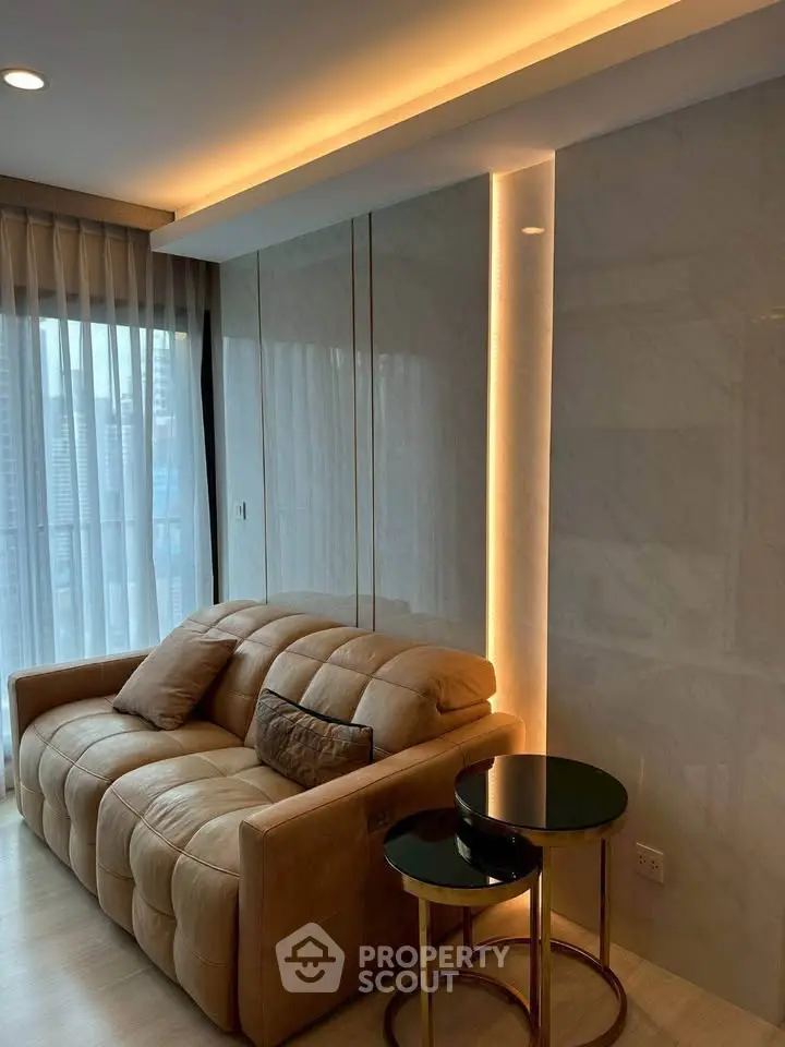 Luxurious living room with plush sofa and elegant lighting, featuring floor-to-ceiling windows with city view.