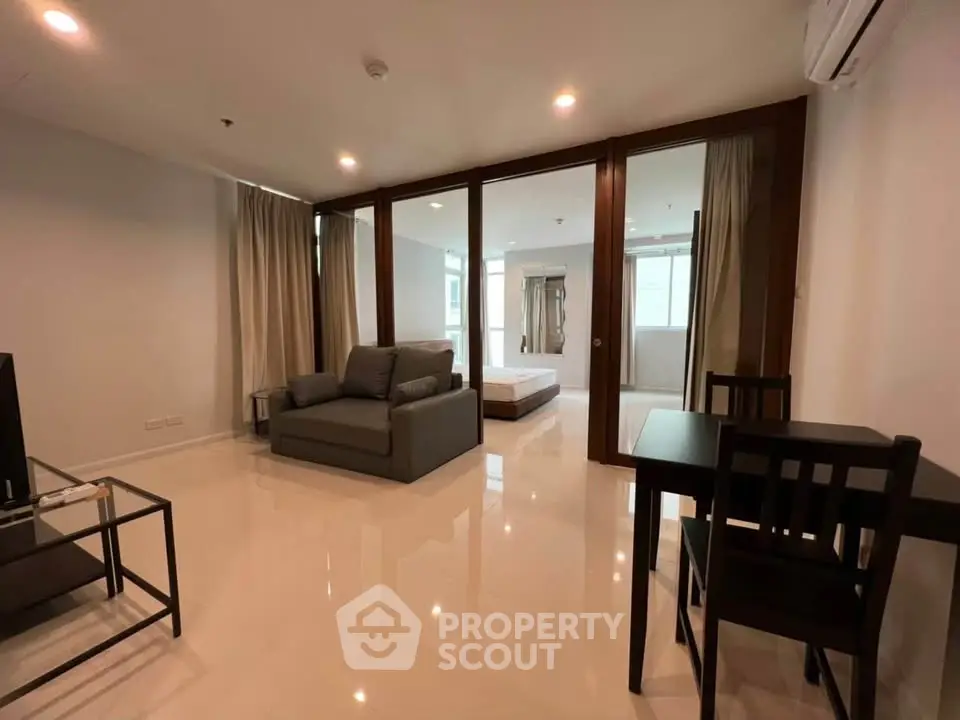 Spacious modern living room with sleek furniture and open layout in a stylish apartment.