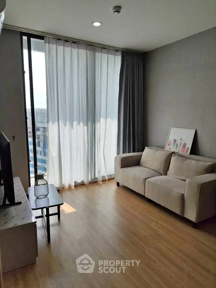 Modern living room with natural light and cozy sofa