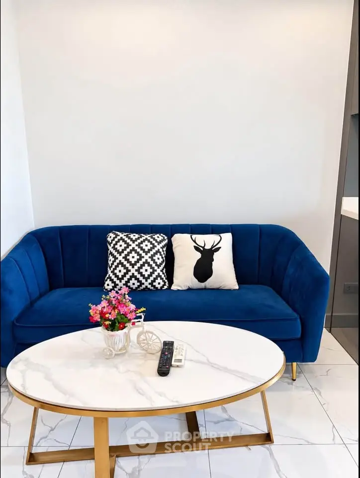 Stylish living room with blue velvet sofa and chic decor
