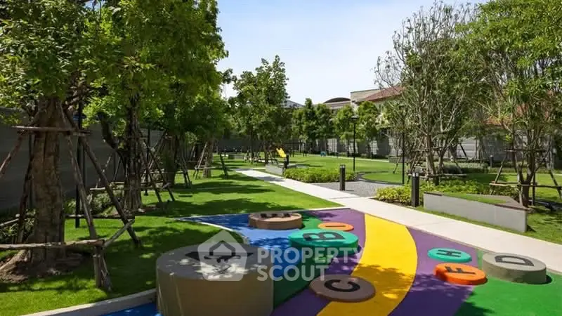 Beautifully landscaped garden with colorful play area in modern residential complex.