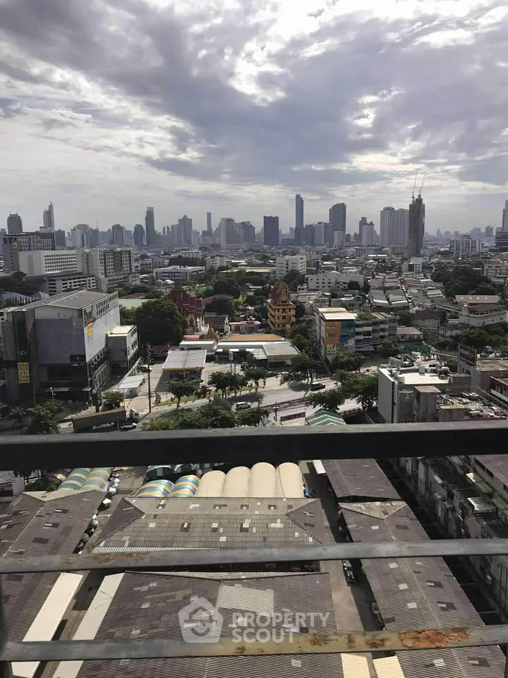 Stunning cityscape view from a high-rise balcony overlooking urban skyline.