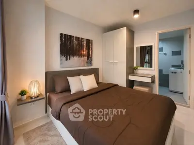 Modern bedroom with cozy decor and ensuite bathroom in a stylish apartment.