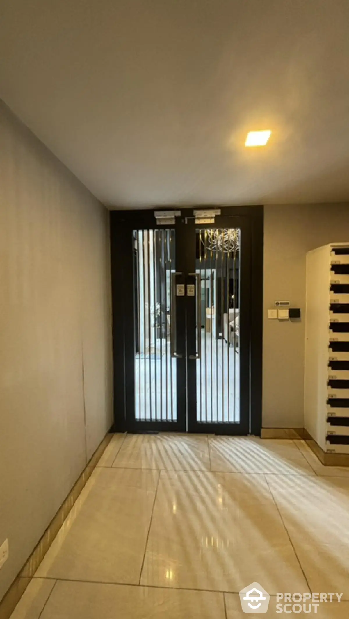 Modern building entrance with sleek design and secure double doors