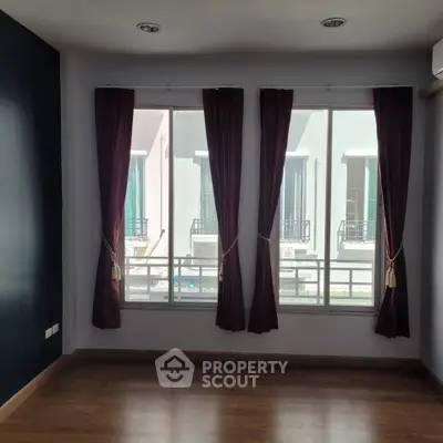 Spacious room with large windows and elegant curtains, perfect for natural light and modern living.