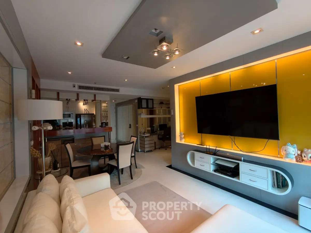Luxurious modern living room with stylish decor and large TV, perfect for relaxation and entertainment.