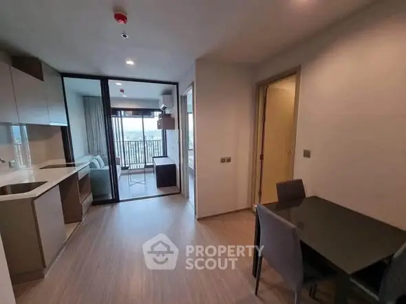 Modern apartment interior with open kitchen and balcony view