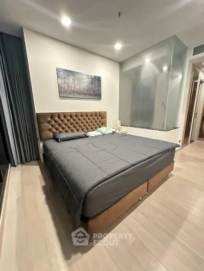 Modern bedroom with stylish decor and plush bed in a cozy apartment setting.