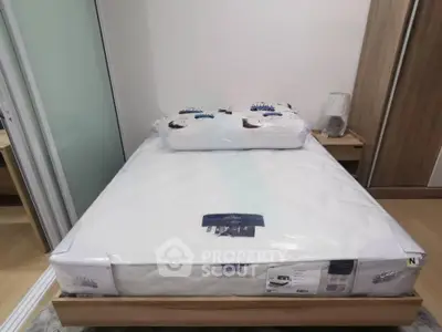 Cozy bedroom with new mattress and wooden furniture, perfect for restful nights.