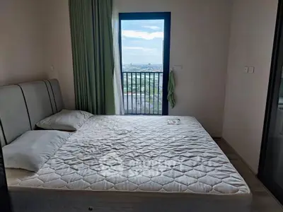 Cozy bedroom with a scenic view from the balcony, featuring a comfortable bed and modern decor.