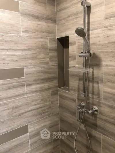 Modern bathroom shower with sleek tile design and chrome fixtures