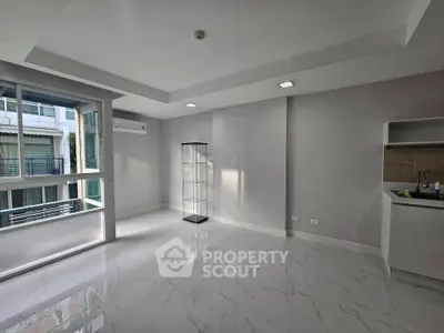 Modern unfurnished apartment with marble flooring and large windows