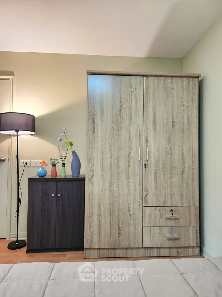 Modern bedroom with stylish wooden wardrobe and cozy lighting