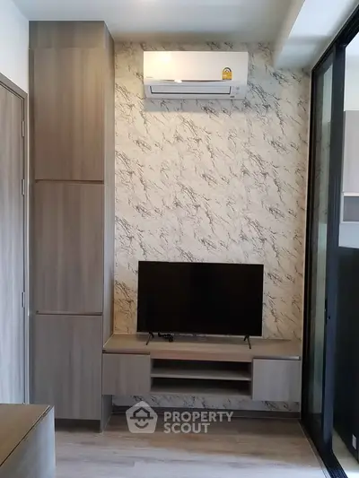 Modern living room with stylish TV setup and air conditioning