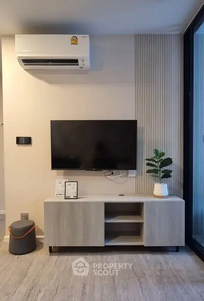 Modern living room with sleek TV setup and air conditioning