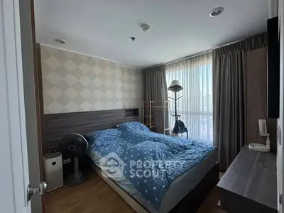 Cozy bedroom with modern decor and large window for natural light.