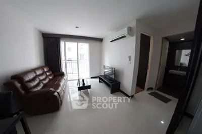 Modern living room with sleek furniture and balcony access in a stylish apartment.