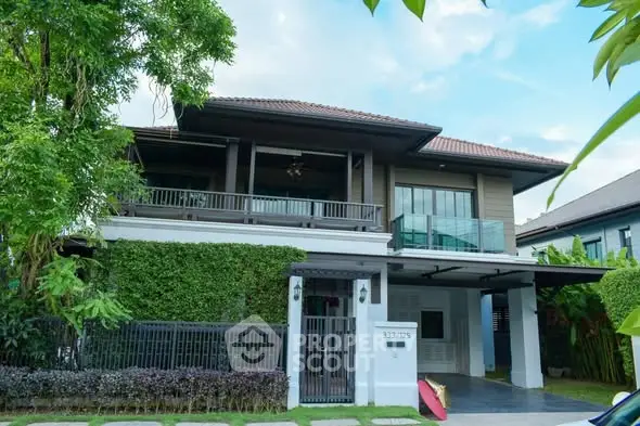 Stunning two-story house with lush greenery and modern design in a serene neighborhood.