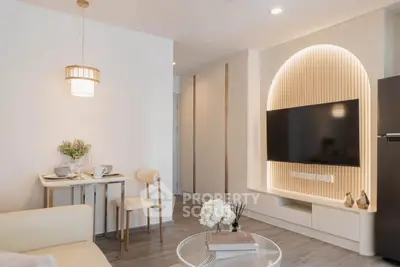 Modern living room with stylish decor and built-in TV unit, perfect for cozy gatherings.
