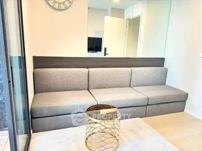 Modern living room with sleek gray sofa and stylish gold coffee table