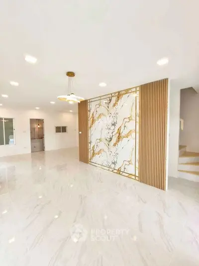 Luxurious modern living room with marble accent wall and elegant lighting