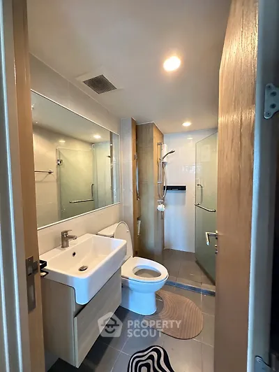 Modern bathroom with sleek fixtures and glass shower enclosure