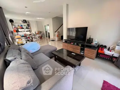 Spacious living room with modern furniture and entertainment setup in a cozy home.