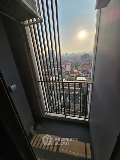 Stunning city view from a high-rise balcony with modern railing design.