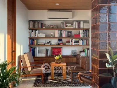 Chic living room with stylish furniture and built-in bookshelf, perfect for modern urban living.