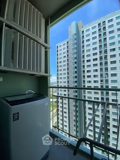 High-rise apartment balcony with washing machine and city view