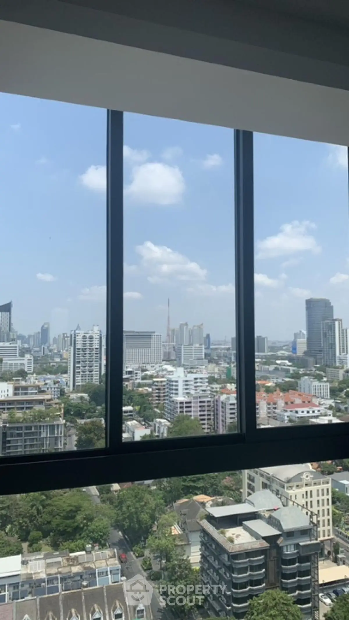 Stunning cityscape view from high-rise apartment window showcasing urban skyline.