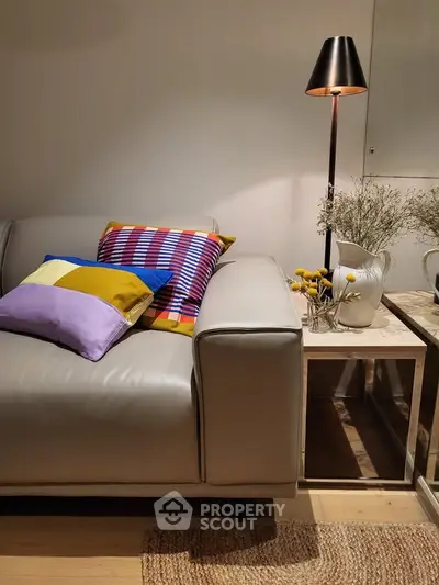 Stylish living room with modern sofa and colorful cushions, perfect for cozy relaxation.
