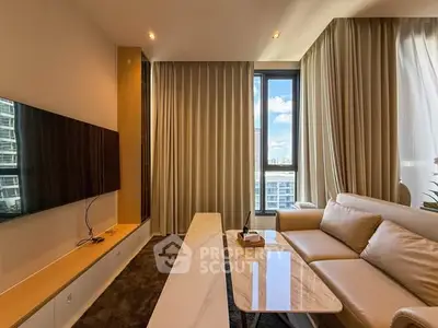 Modern living room with large window and elegant furnishings in a high-rise apartment.