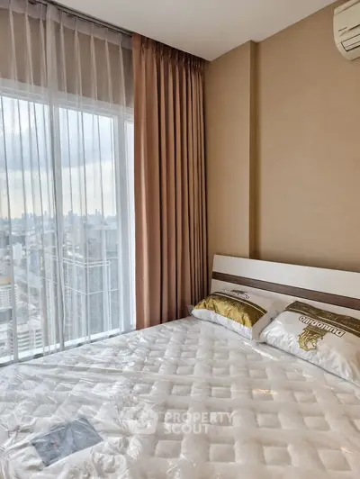 Modern bedroom with city view and elegant decor in high-rise apartment