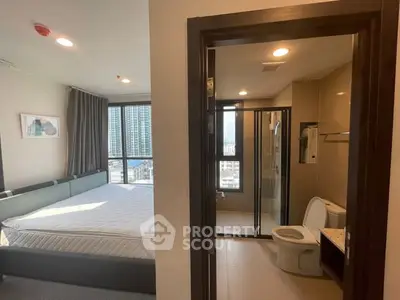 Modern bedroom with ensuite bathroom and city view, featuring large windows and stylish decor.