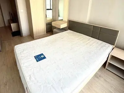 Spacious bedroom with modern furnishings and ample natural light in a stylish apartment.