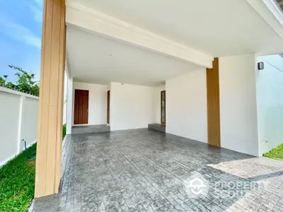 Spacious modern entrance with sleek tiled flooring and wooden accents, perfect for welcoming guests.