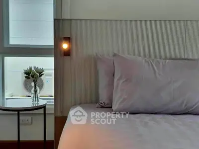 Cozy bedroom with modern decor and soft lighting, perfect for relaxation.