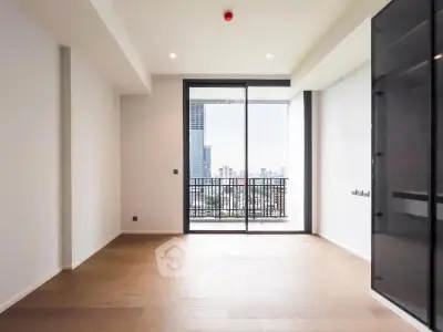 Spacious modern living room with large balcony and city view, perfect for urban living.