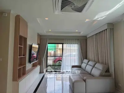 Modern living room with sleek design and large window view.