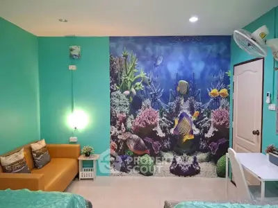Vibrant living room with ocean-themed wall mural and cozy seating area
