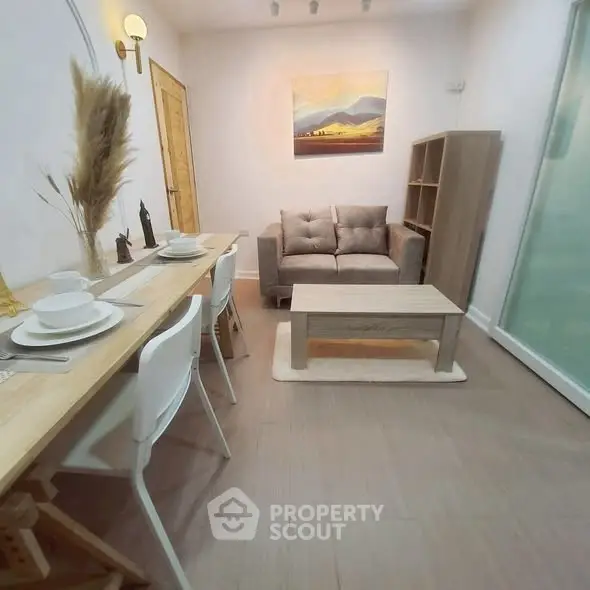 Cozy living room with modern decor and dining area, perfect for small gatherings.