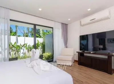 Luxurious bedroom with large TV and garden view, featuring elegant decor and natural light.