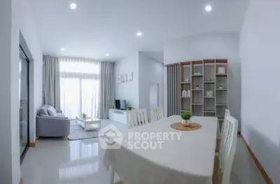 Spacious modern living room with dining area and natural light