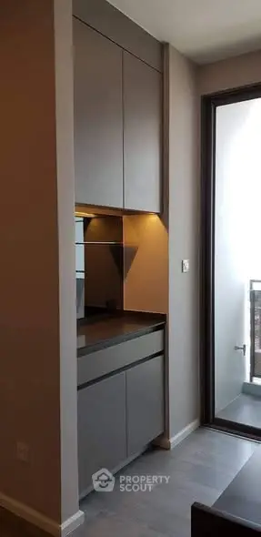 Modern kitchen with sleek cabinets and balcony access