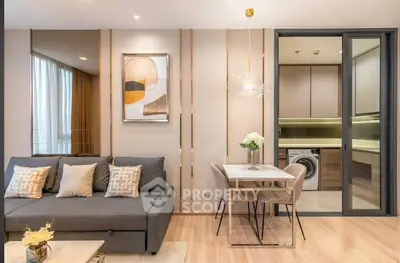 Modern living room with stylish decor and open kitchen featuring washing machine.
