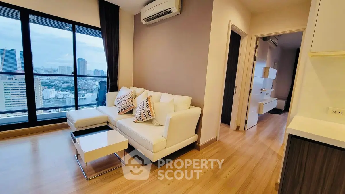 Modern living room with city view and stylish decor in high-rise apartment